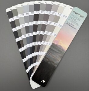selection of grey, black and beige colours on Pantone fan