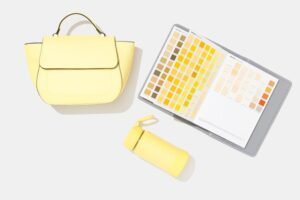 Yellow handbag and container with pantone book for colour selection