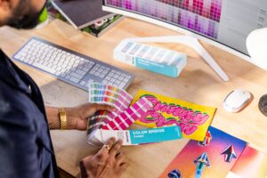 Designer working at desk with Pantone Color Bridges