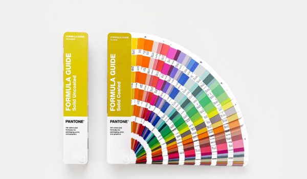 Pantone GP1601C. Formula Guide Set books with yellow covers, one is fanned open to show the colour charts