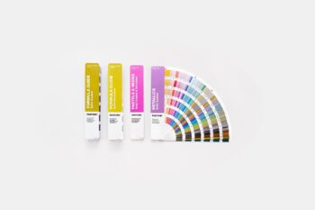 4 fan decks of Pantone colours on a desk