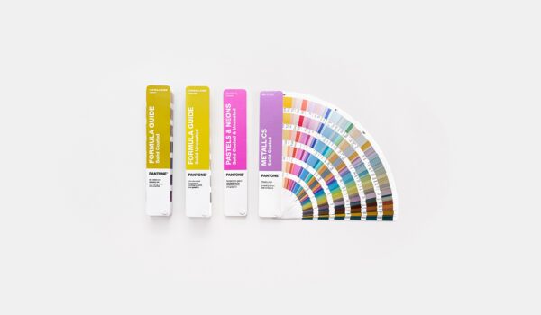 4 fan decks of Pantone colours on a desk