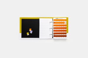 Pantone GP1606C Solid Chips book open to show page of colour chips