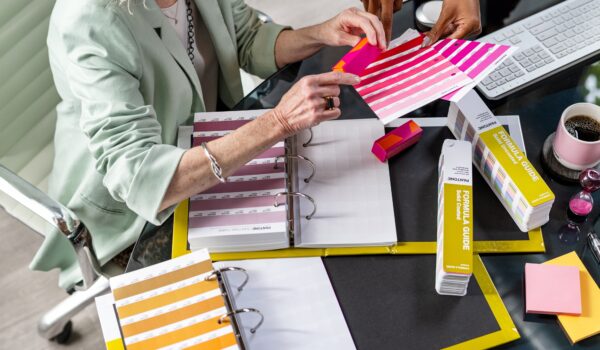 designer using Pantone solid chips to pick colours