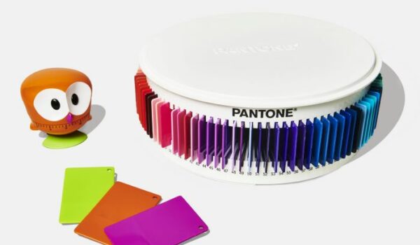 A carousel of multi coloured Pantone plastic colour plaques and a plastic toy